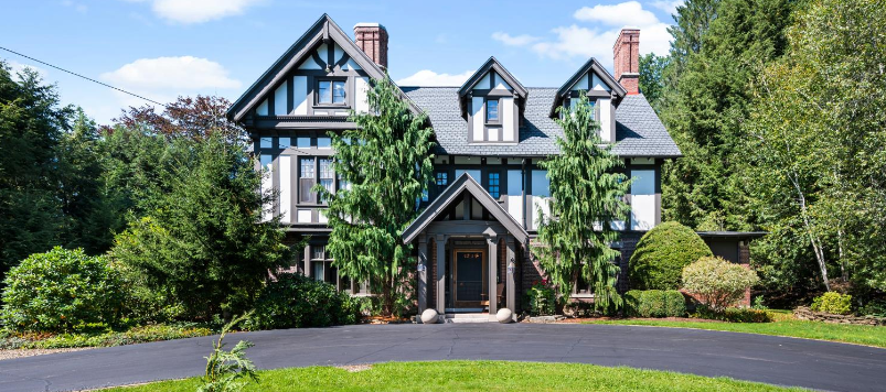 A large house with a lot of windows and trees in front of it