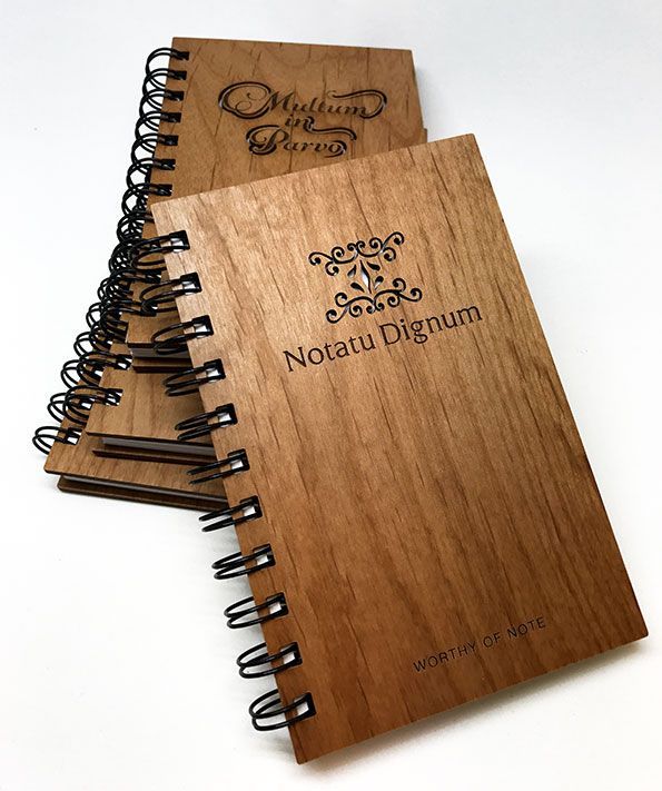 a wooden notebook with the name notatu dignam on it