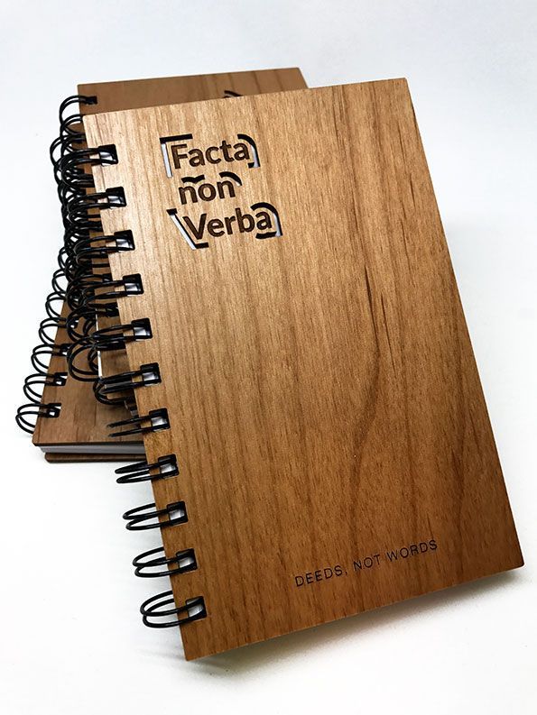 two wooden notebooks with the words facta non verba on them