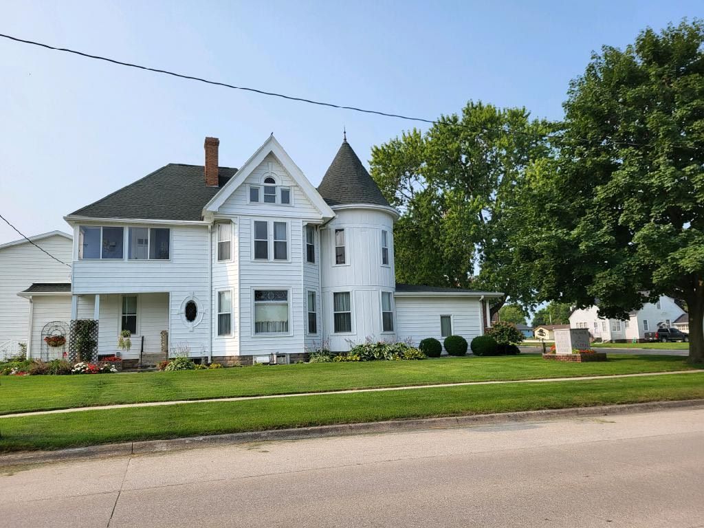 A large white house with a tower on top of it