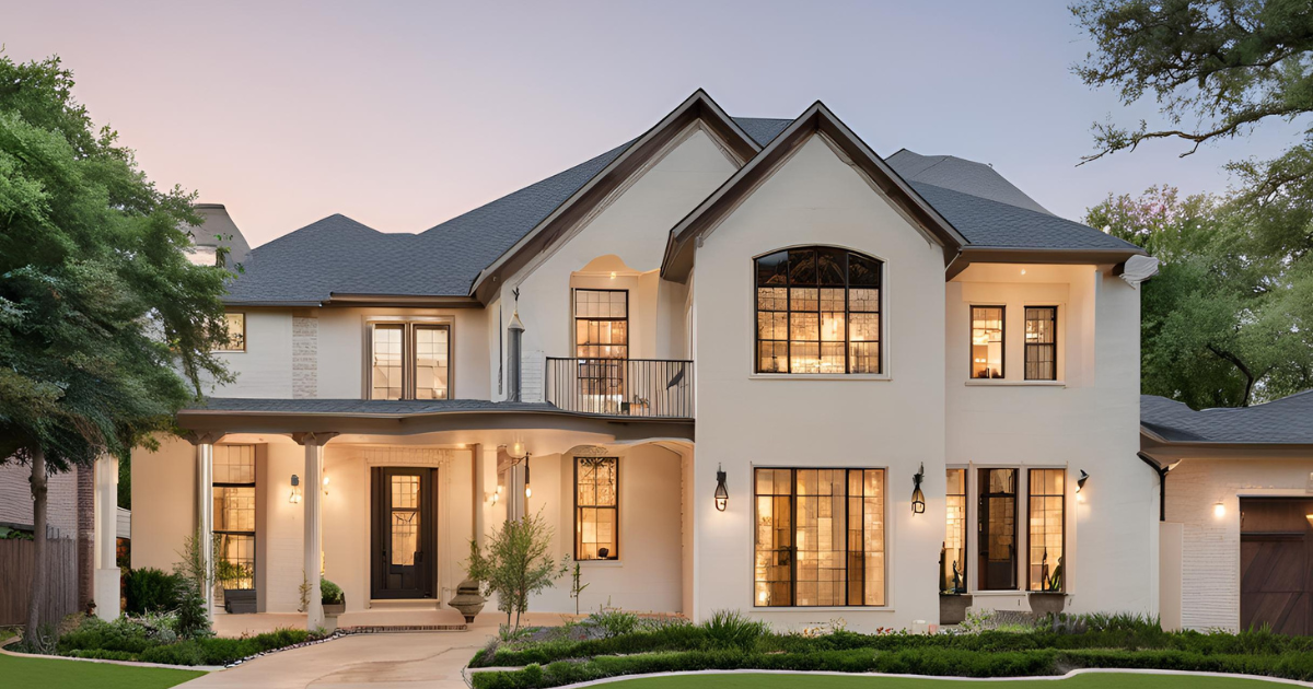 A large white house with a gray roof and lots of windows