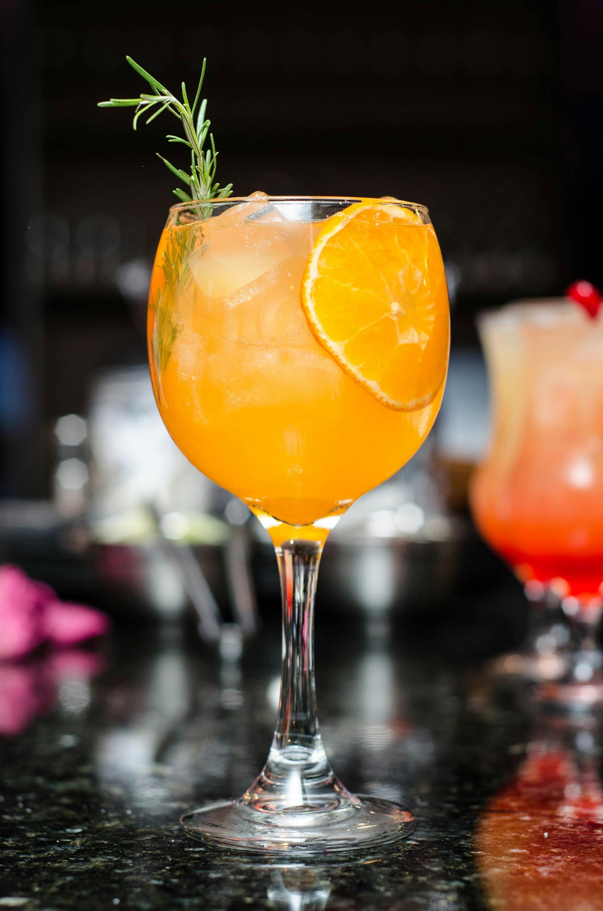 A close up of a glass of orange juice on a table.