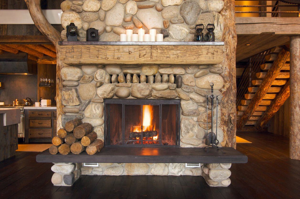 wood fireplace with stone facade installed by ener-g tech, inc.
