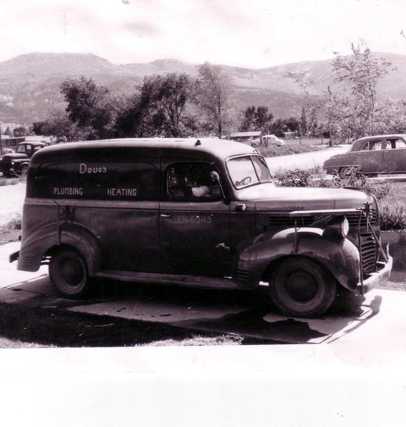 A black and white photo of an old dodge van