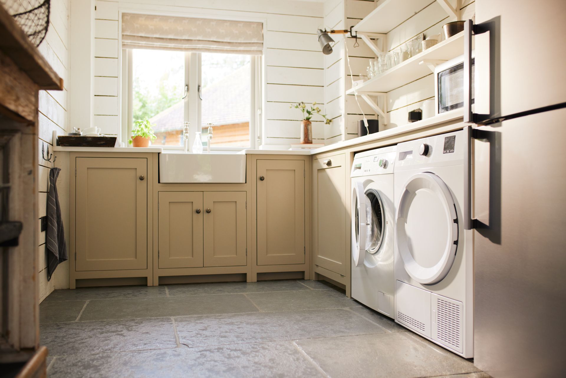 A laundry room with a washer and dryer and a sink.
