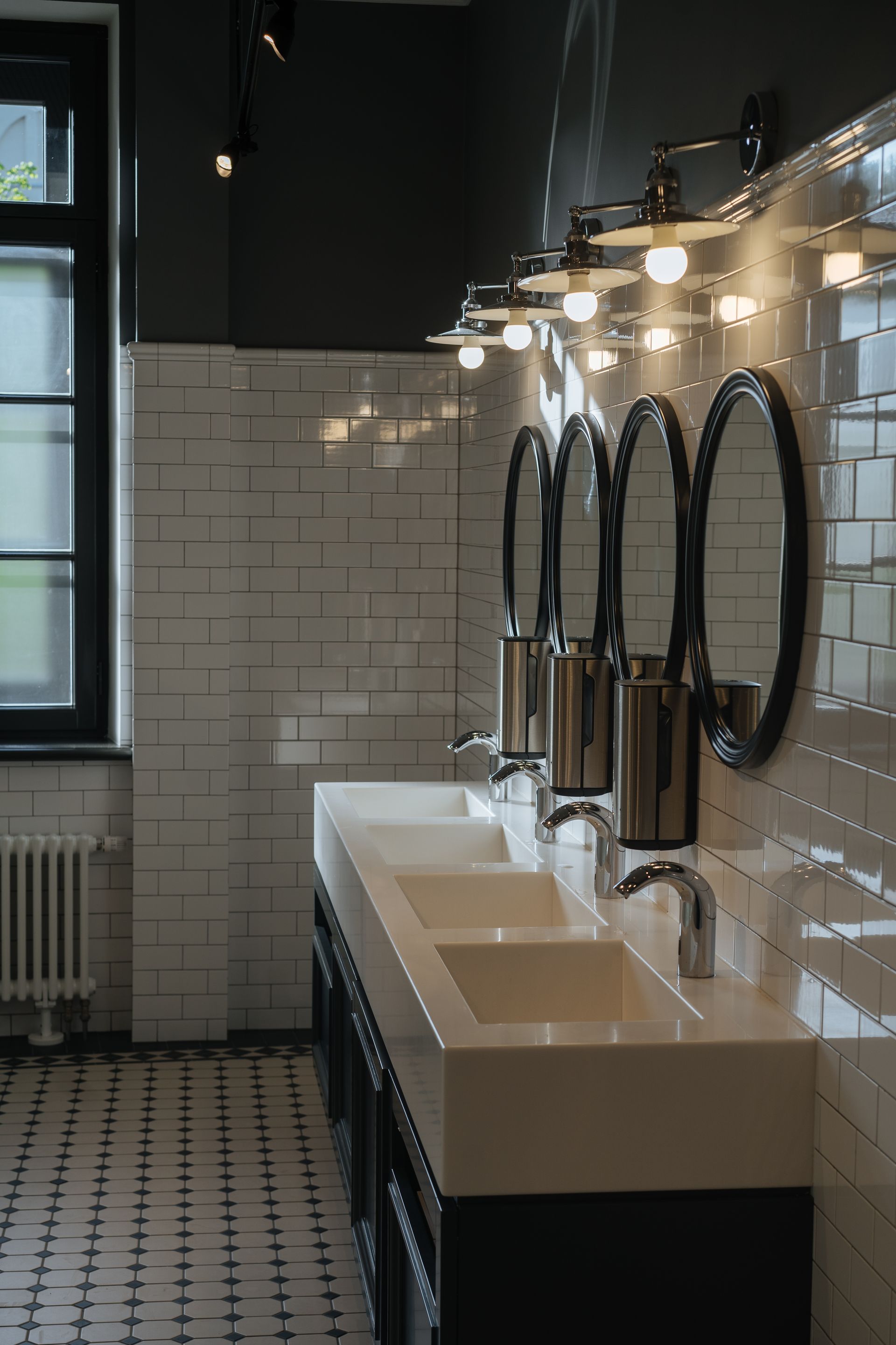 A bathroom with a lot of sinks and mirrors