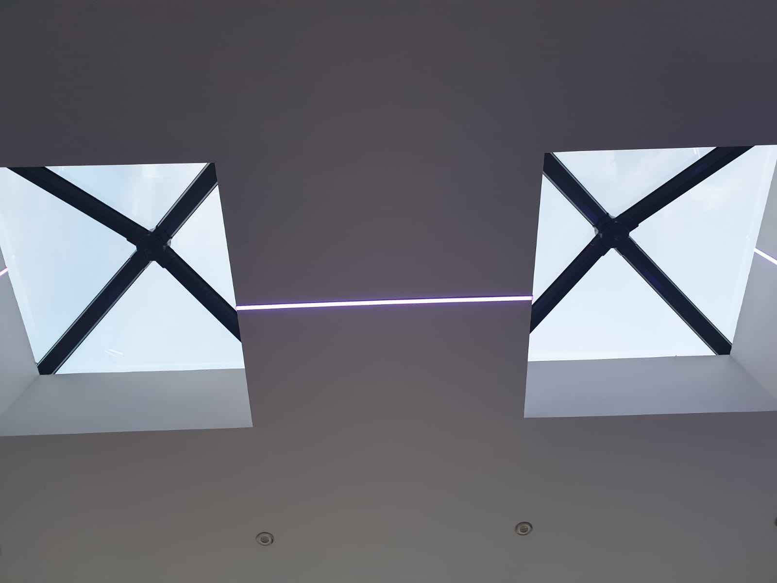 A ceiling with two skylights with x 's on them