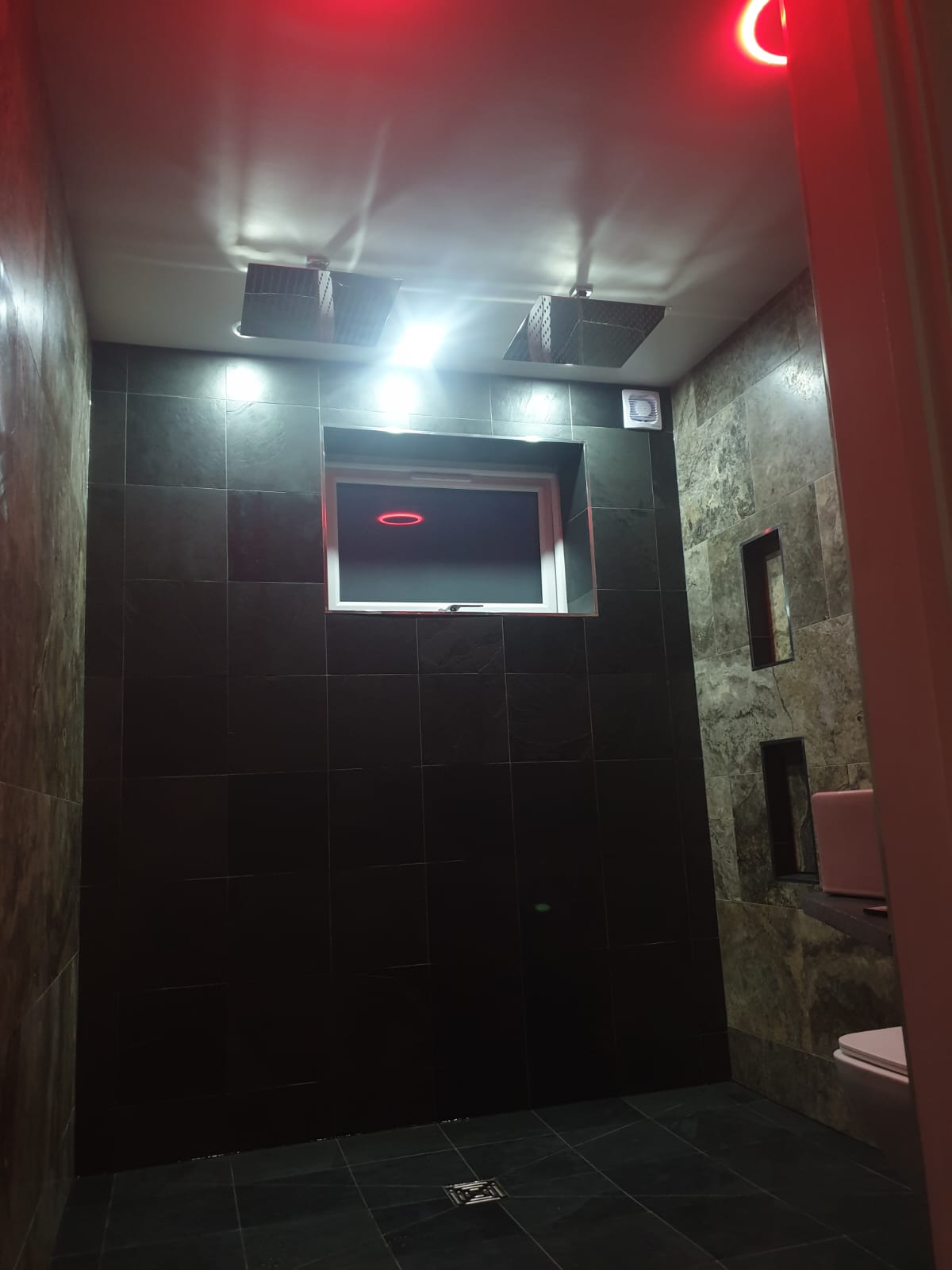 A bathroom with a red light that says c on it