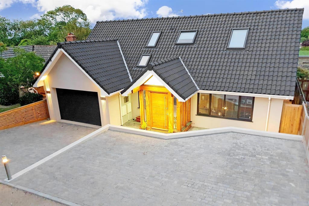 An aerial view of a house with a black roof