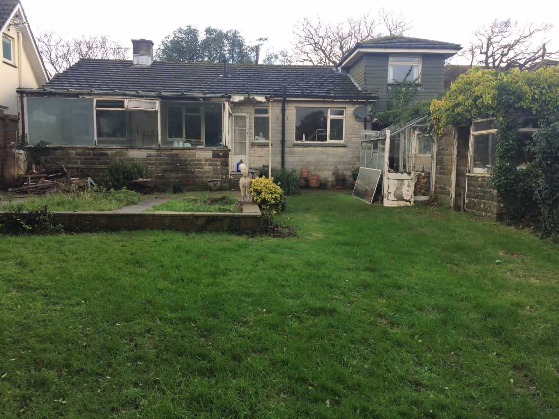 A house with a large lawn in front of it.