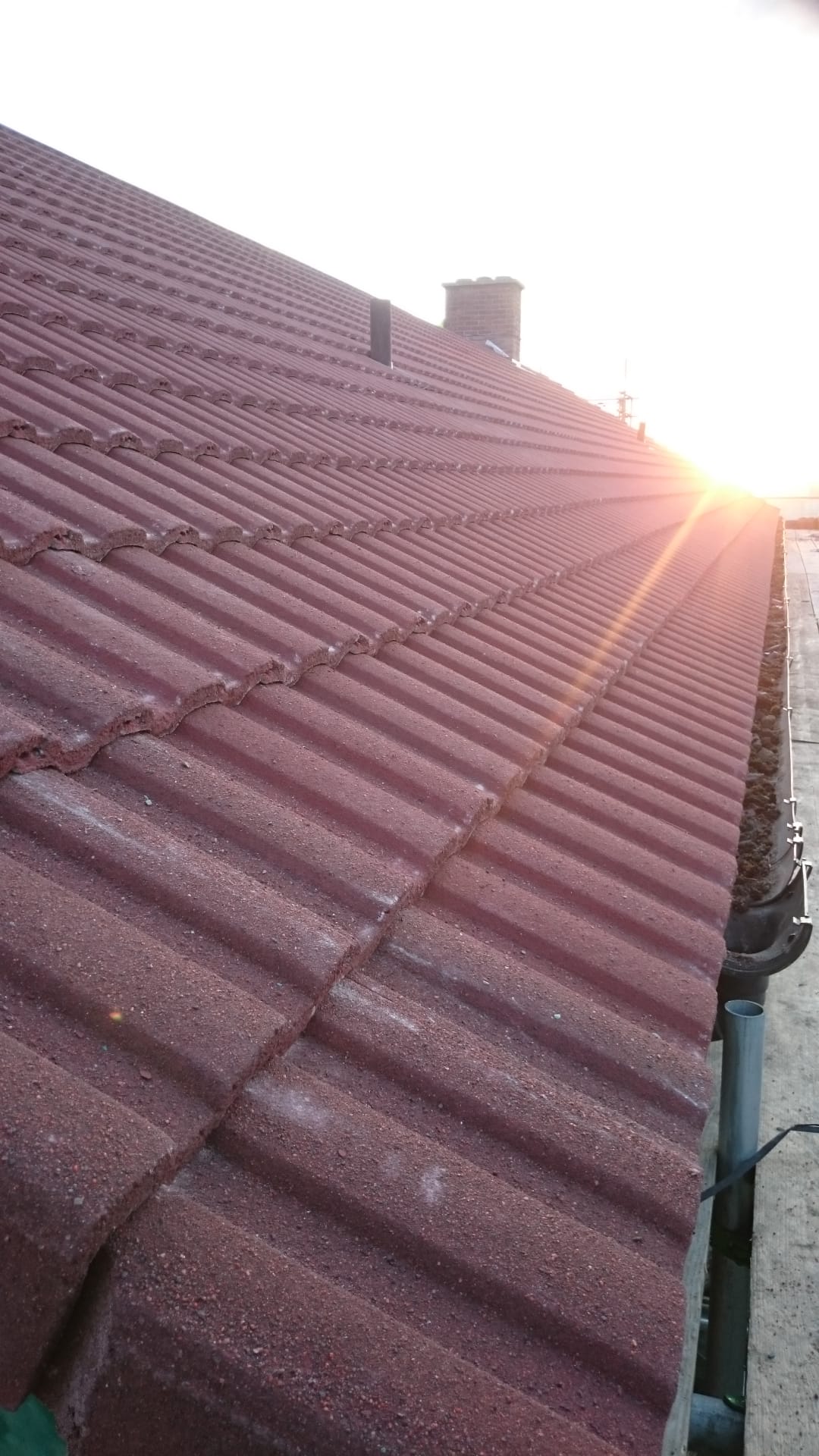 The sun is shining through the roof of a building.