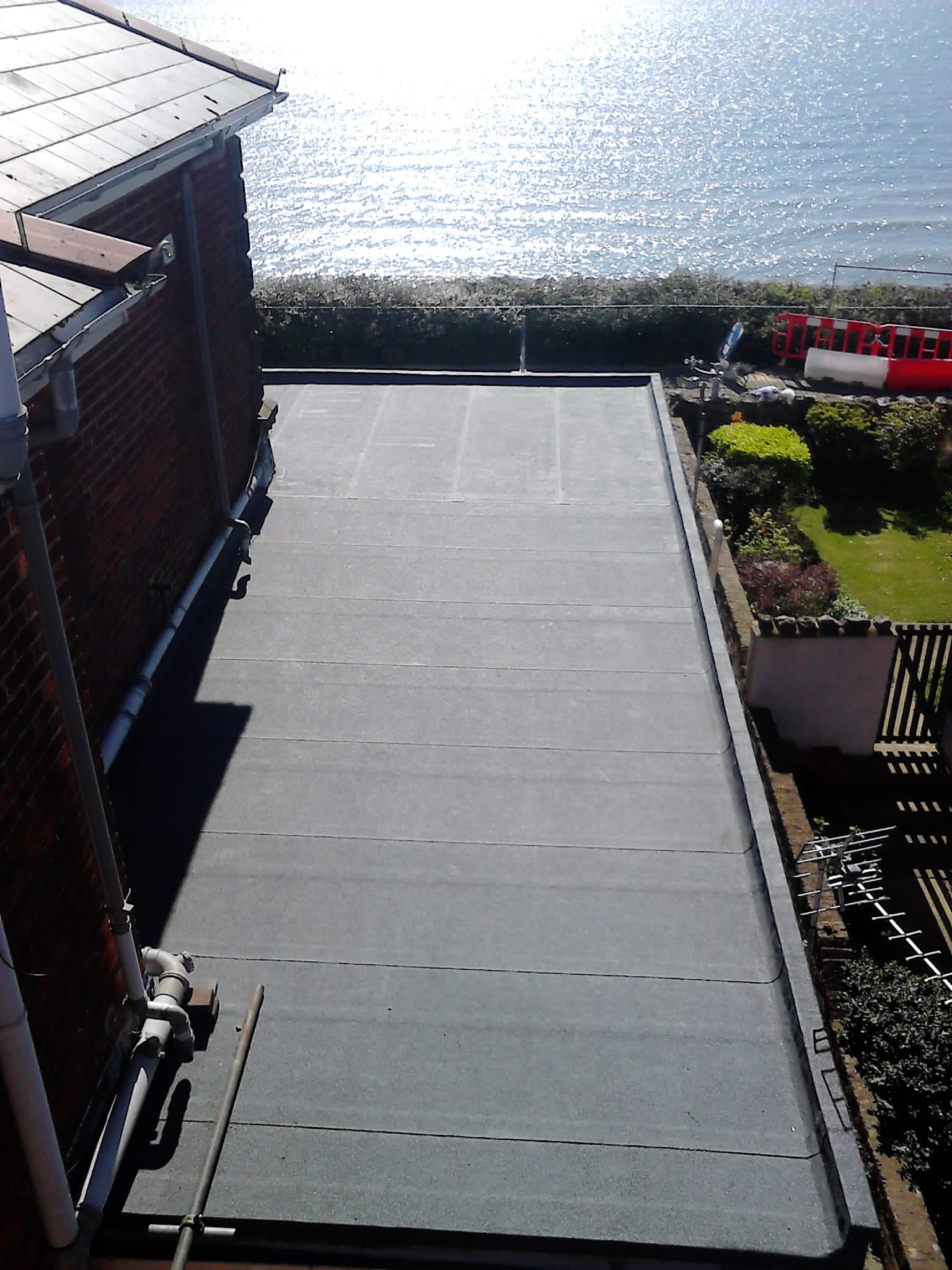 A view of the ocean from the roof of a house