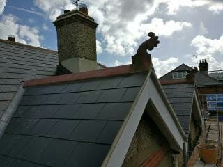 A roof of a building with a chimney on top of it.