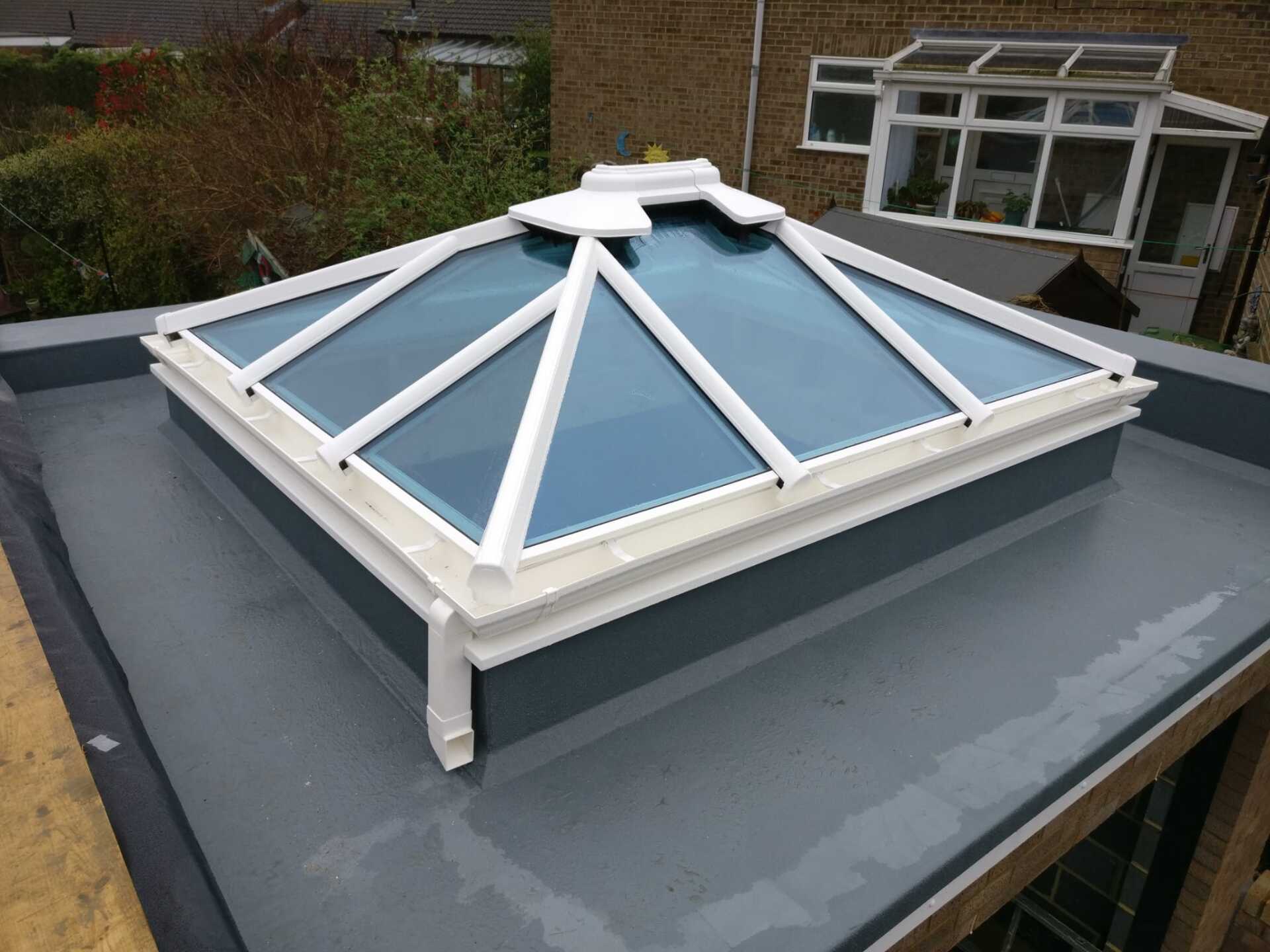 A roof with a skylight on top of it.
