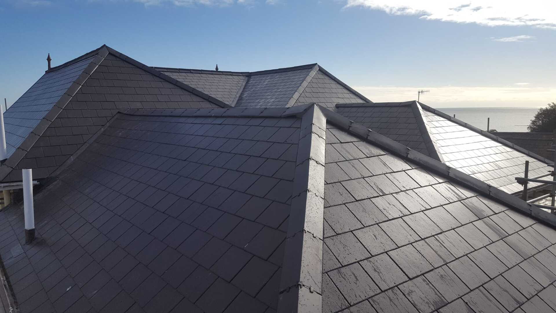 A roof with a blue sky in the background