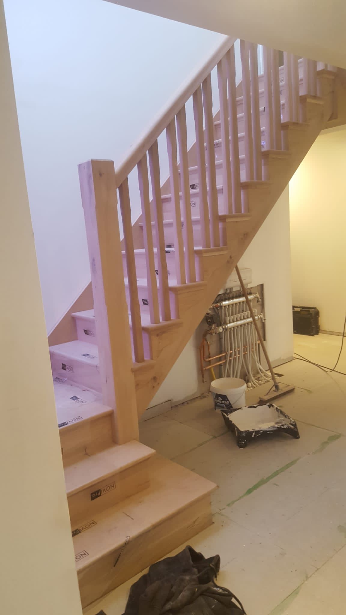 A wooden staircase is being built in a room.