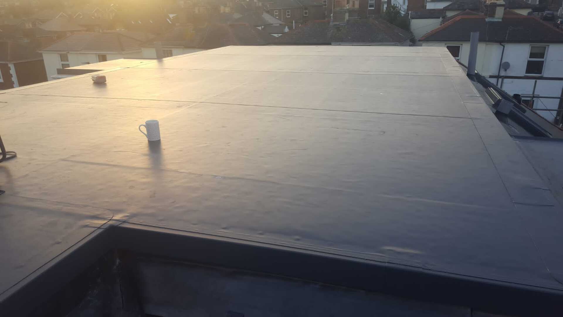 The sun is shining on the roof of a building.