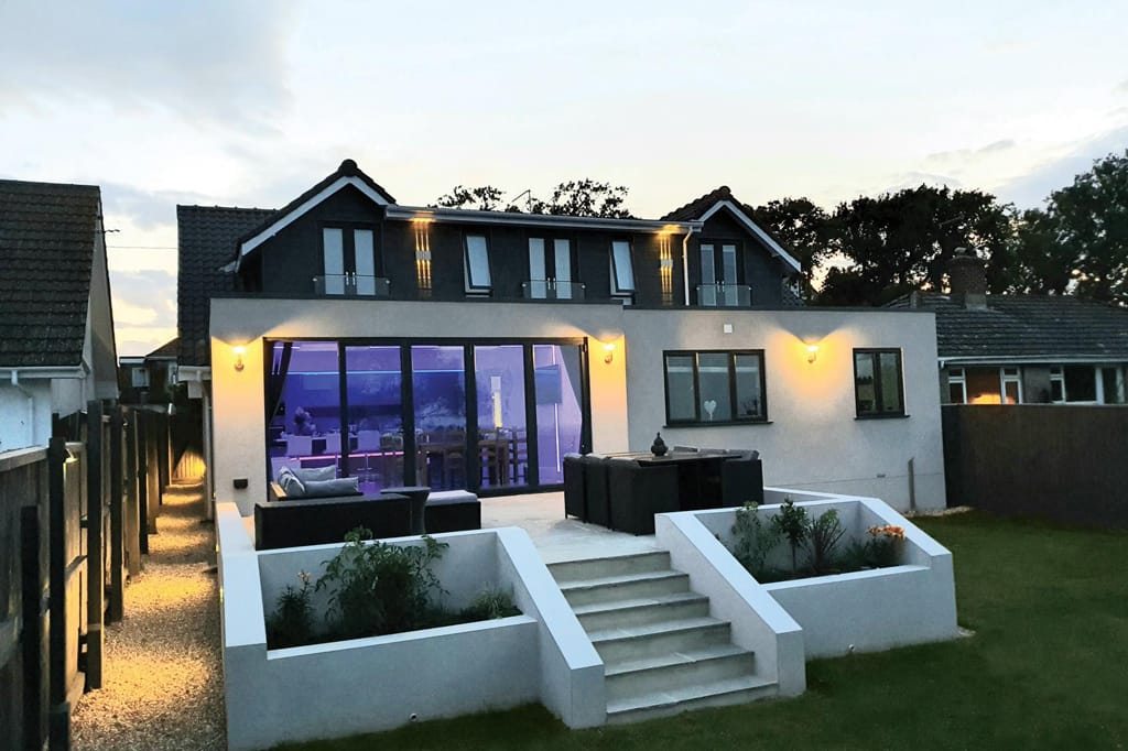 A large white house with stairs leading up to it