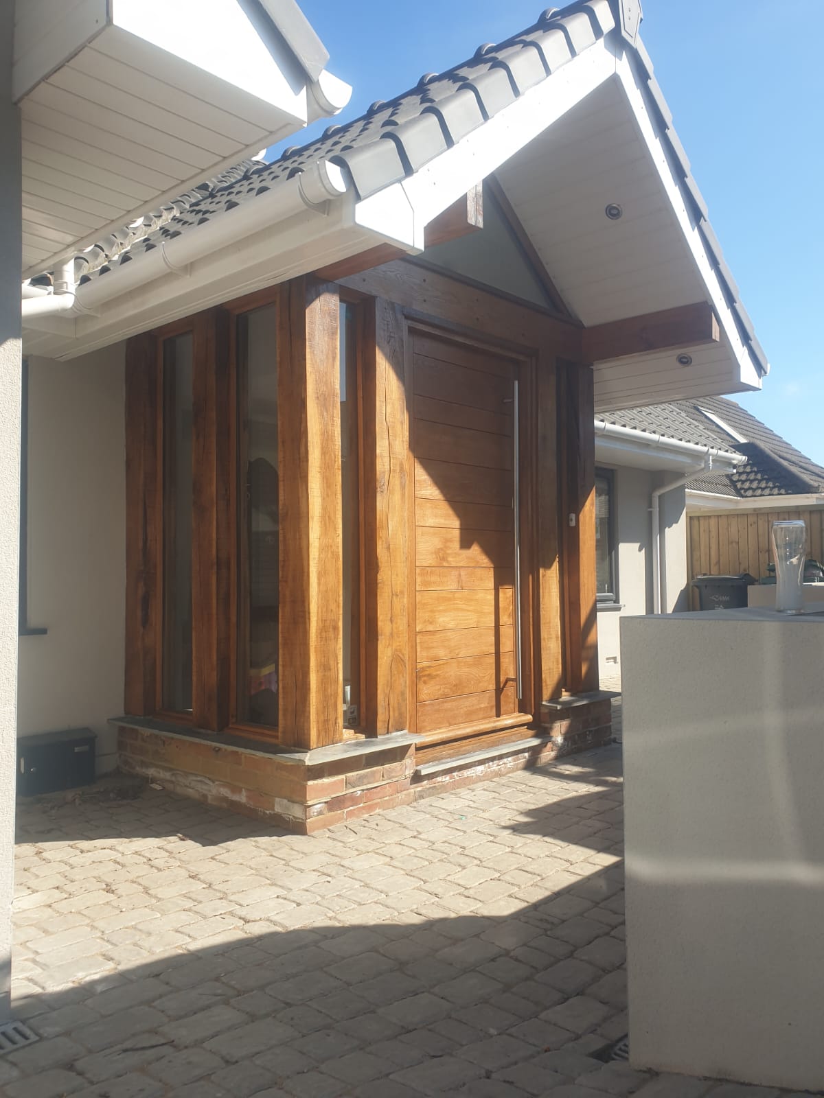 A house with a wooden door and a white roof