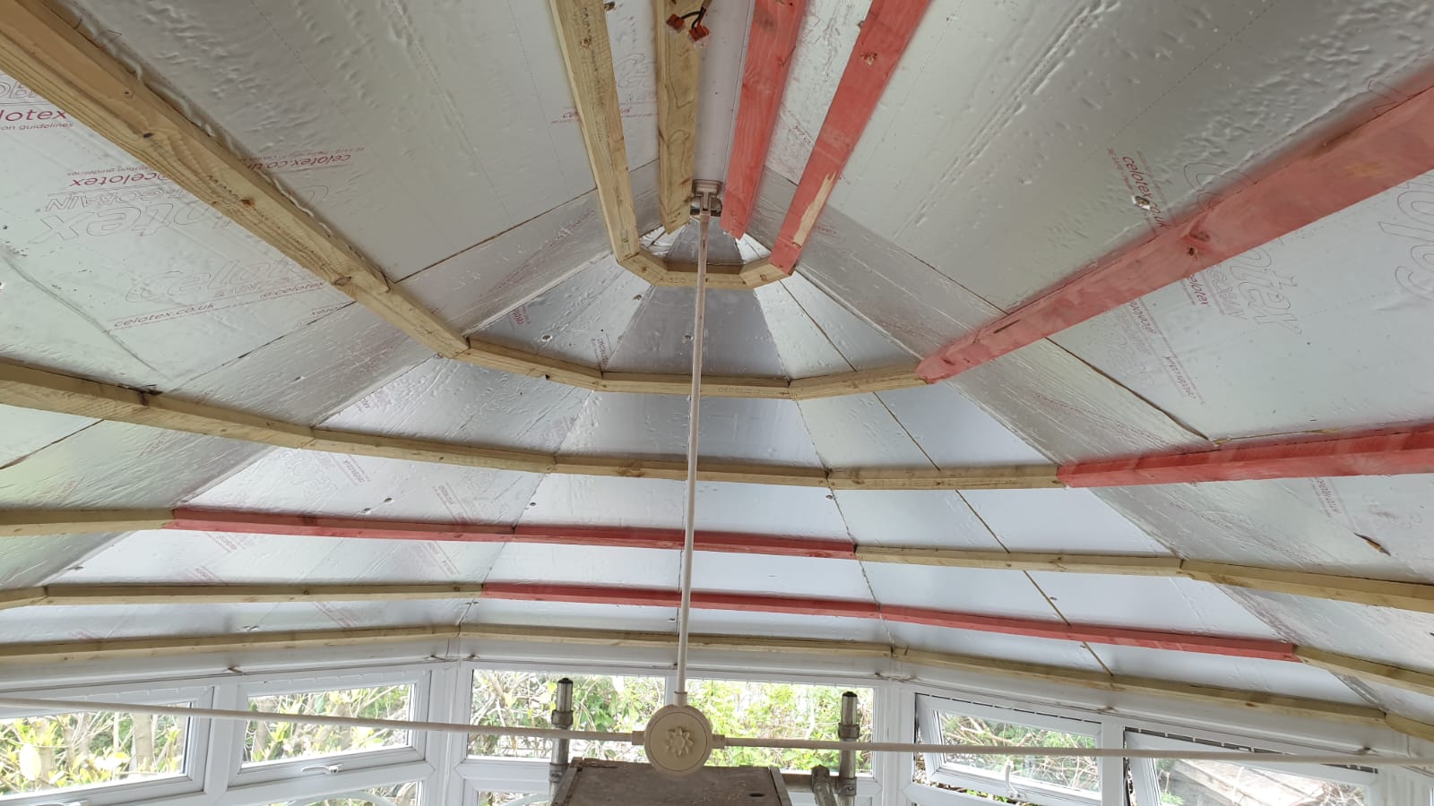 A ceiling fan is hanging from the ceiling of a building.