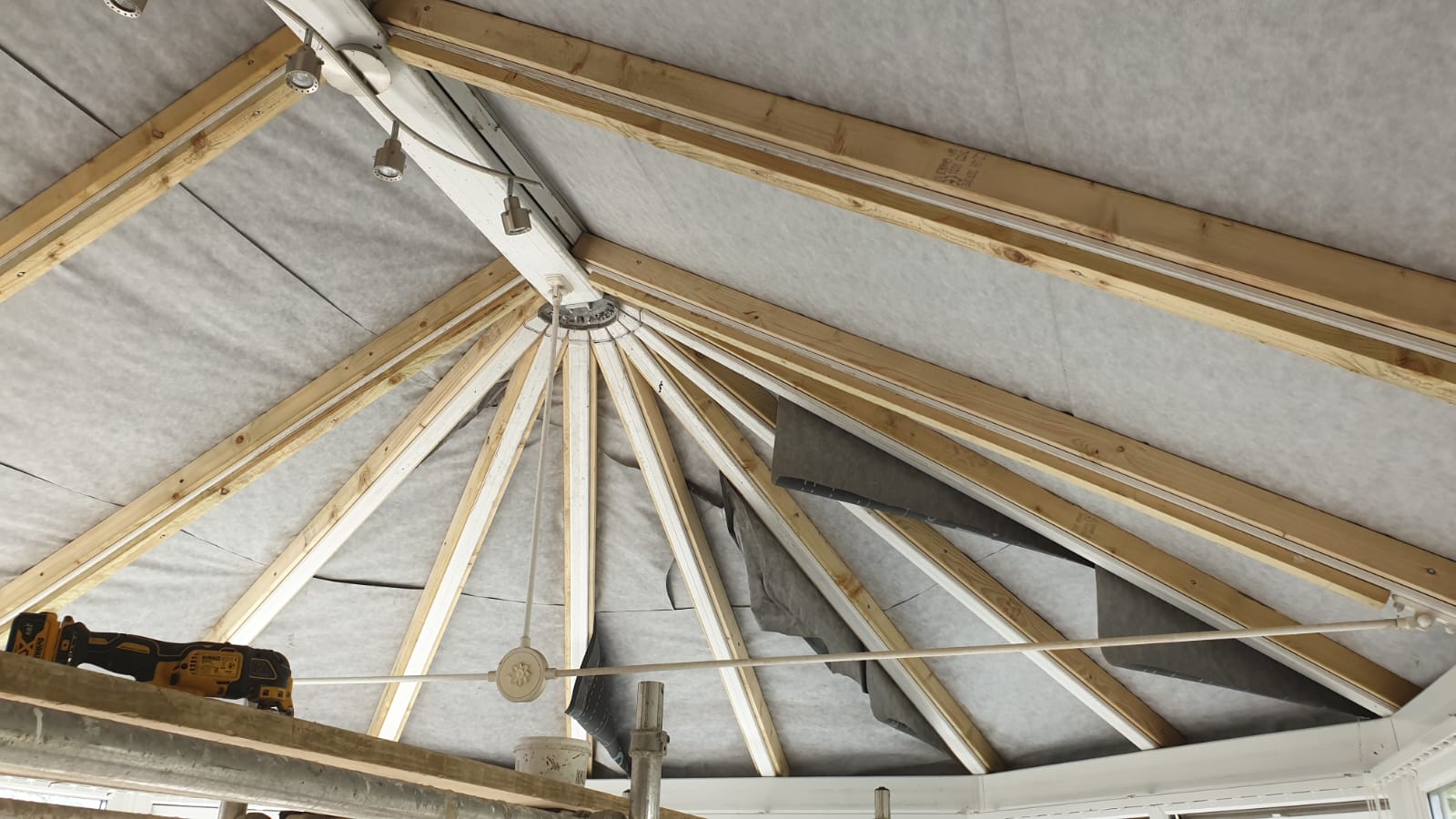 The ceiling of a building is made of wooden beams