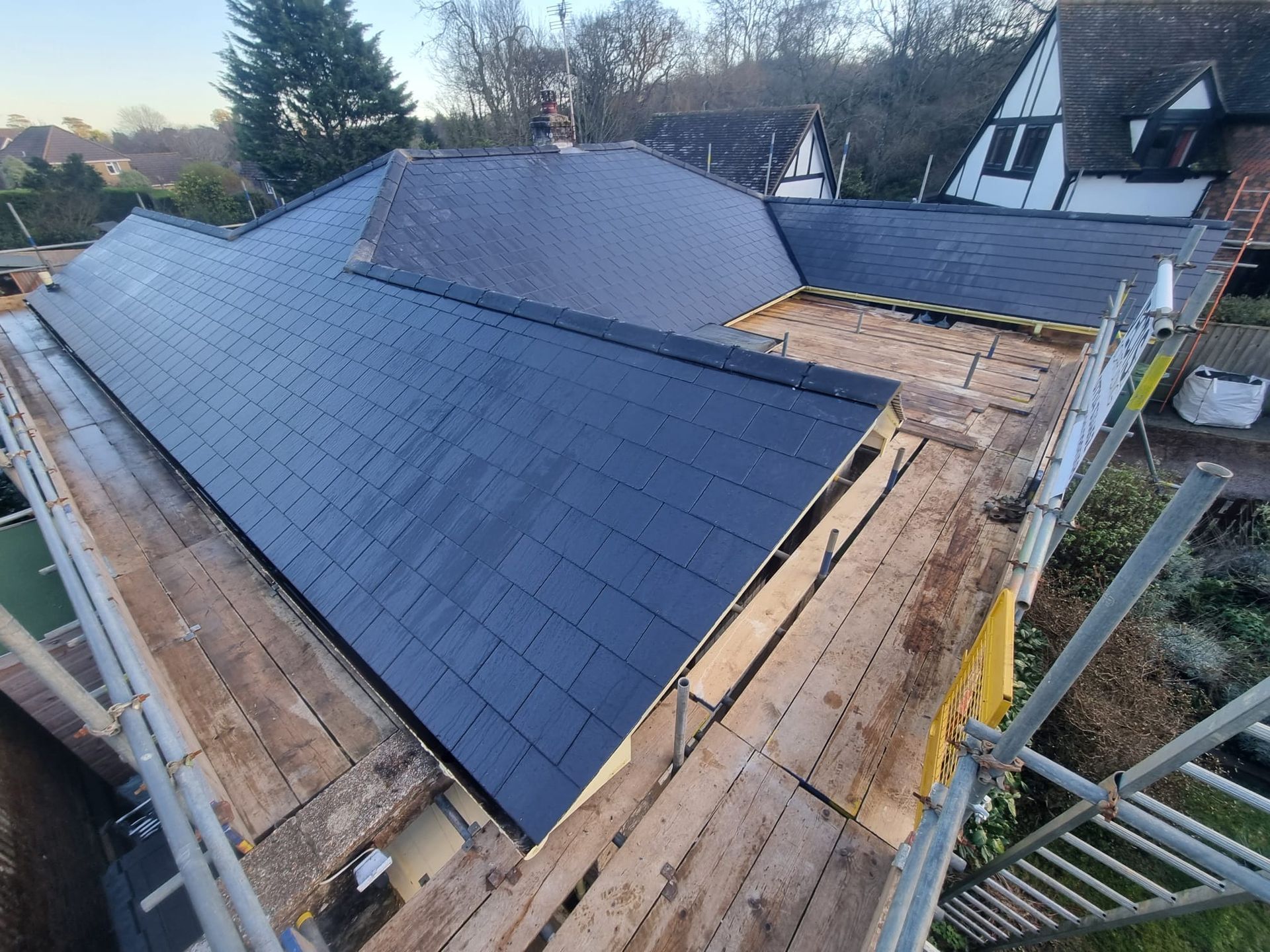 a house with a slate roof is being built .