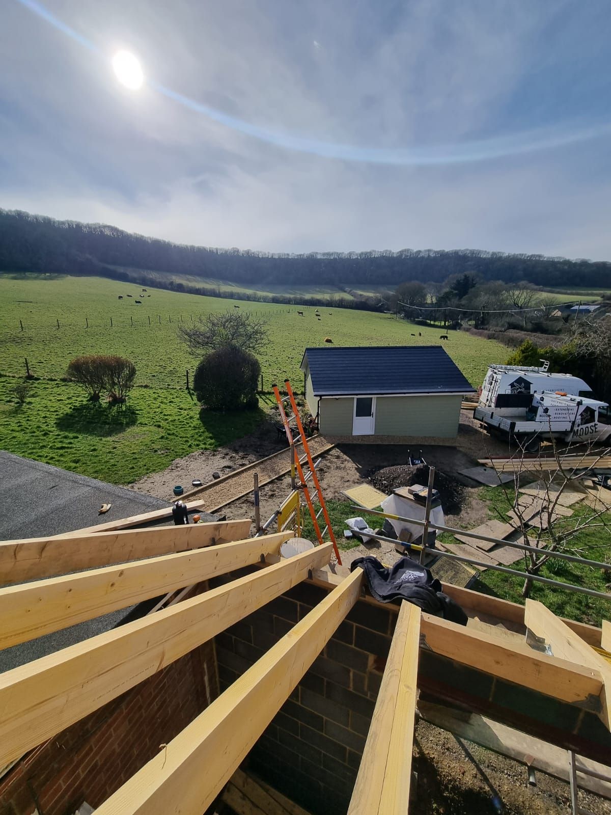 A house is being built in the middle of a field.