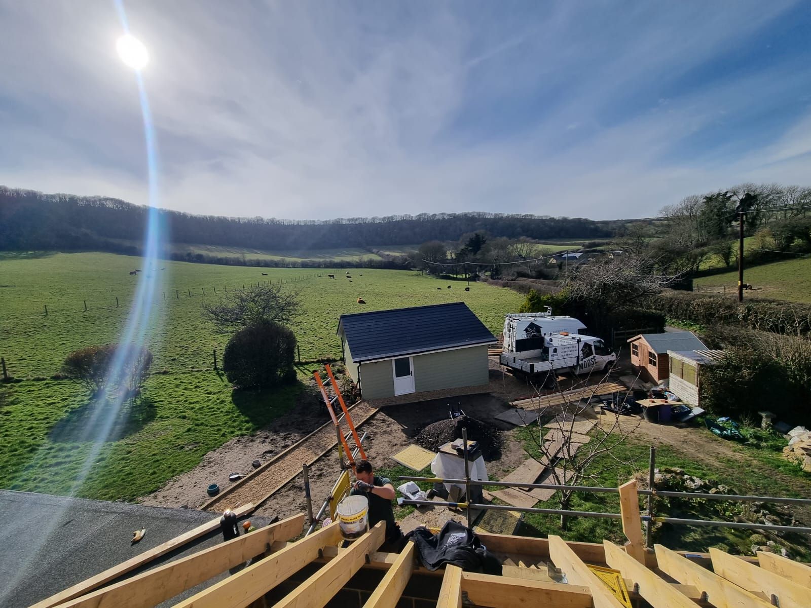 A house is being built in the middle of a field.