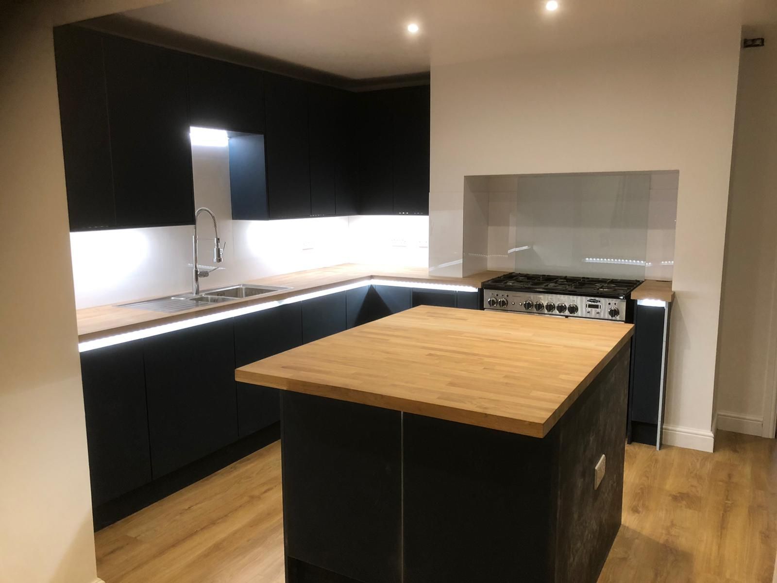 A kitchen with a large island in the middle of it.