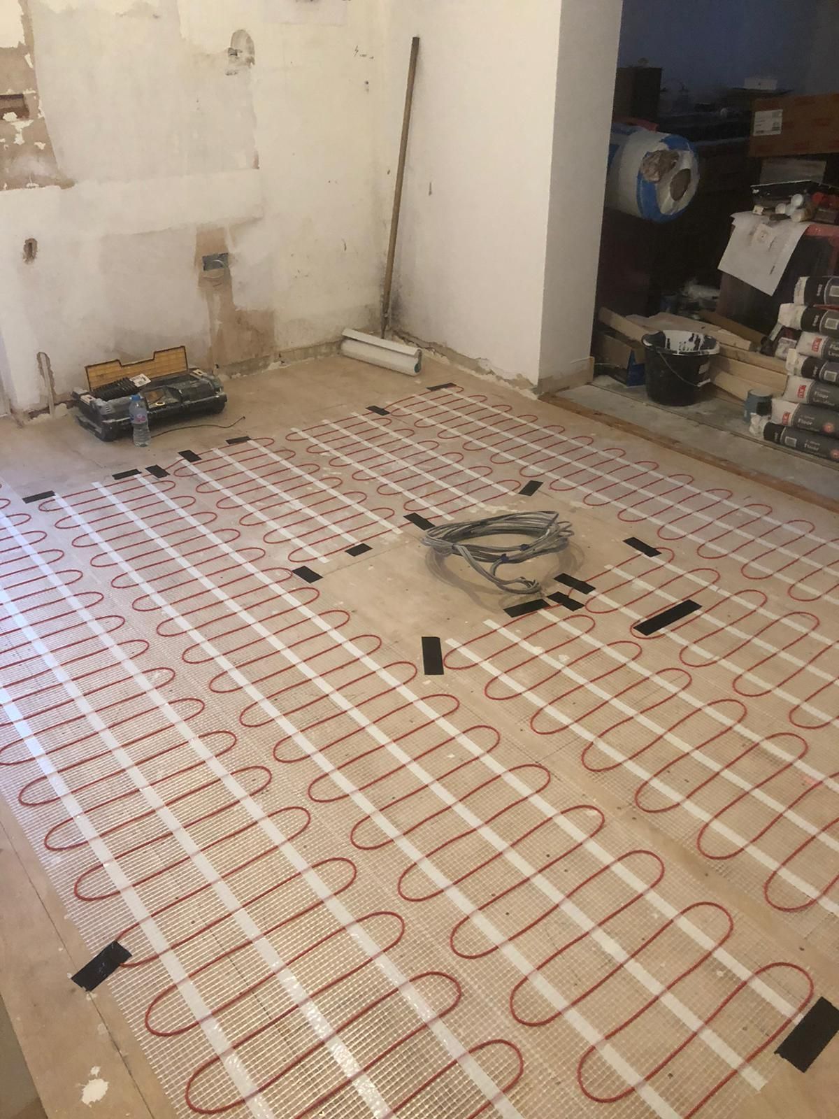 A room with a lot of electrical wires on the floor.
