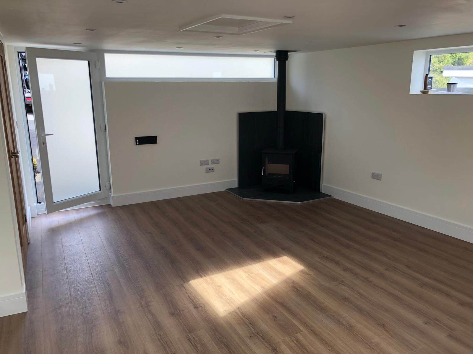 There is a fireplace in the corner of the room.