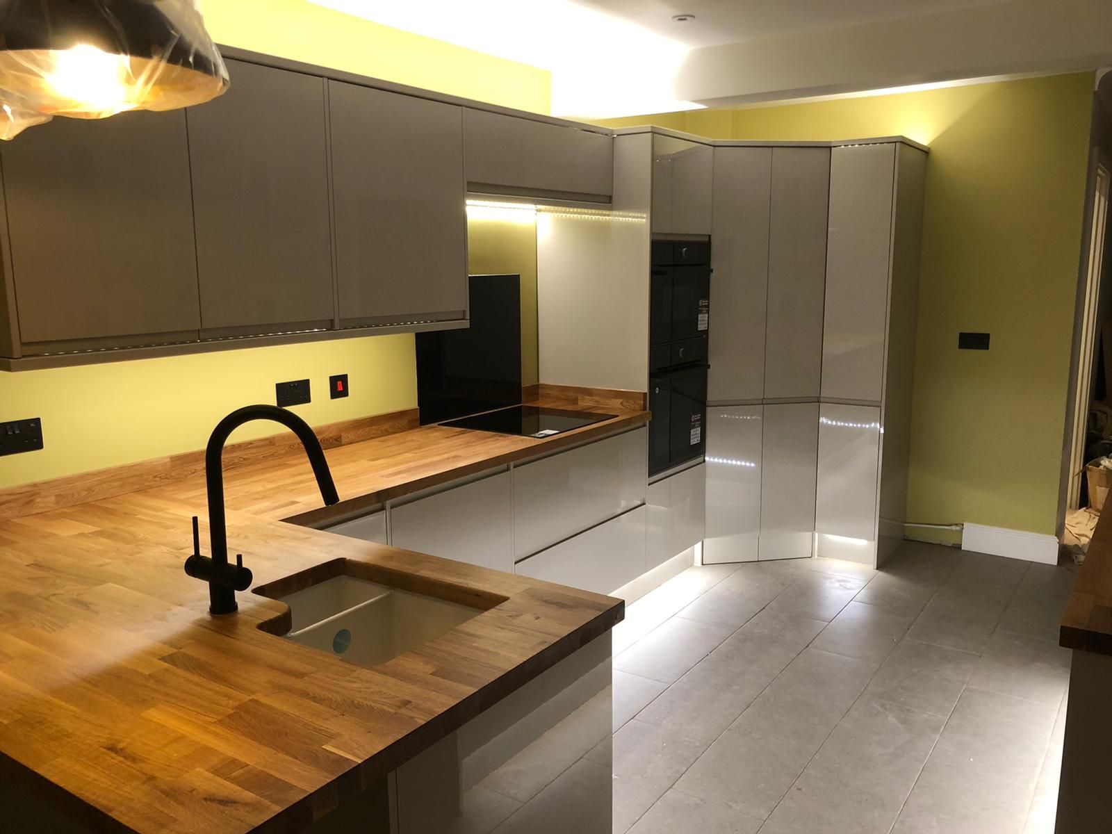 A kitchen with wooden counter tops and a sink.