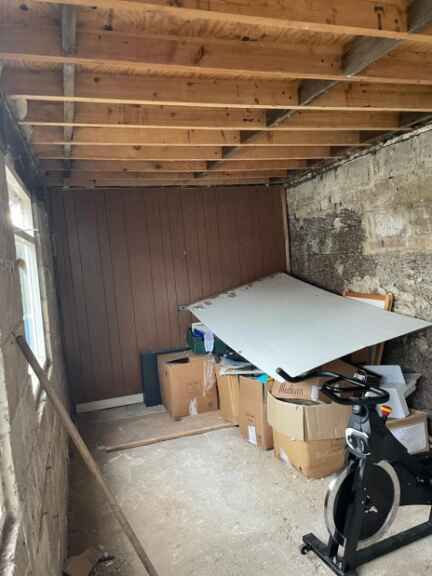 A room filled with boxes and a spinning bike.