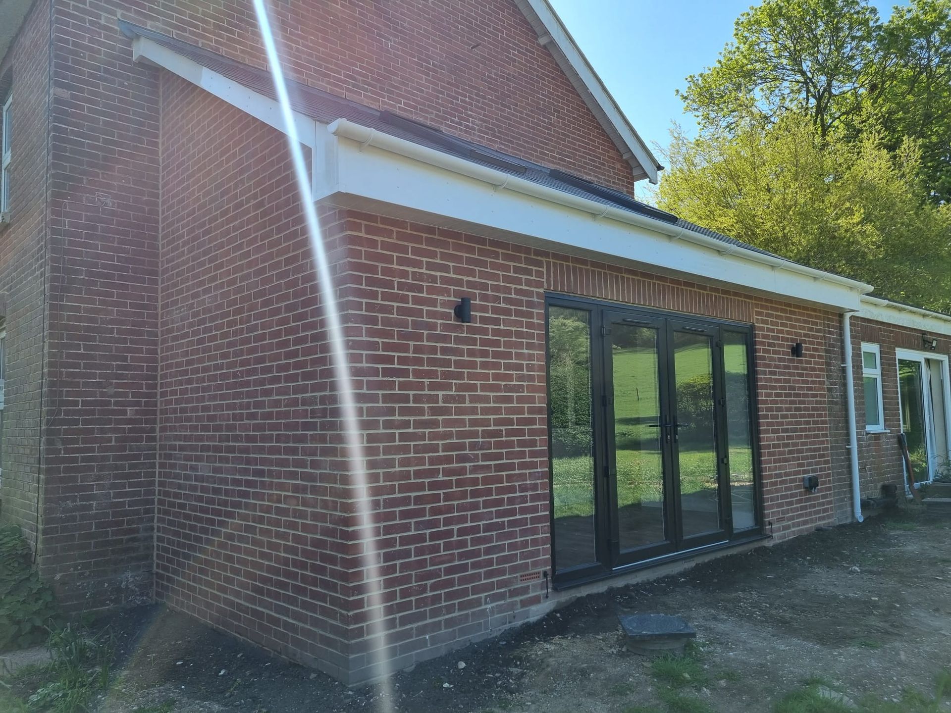 A brick house with a sliding glass door on the side of it.