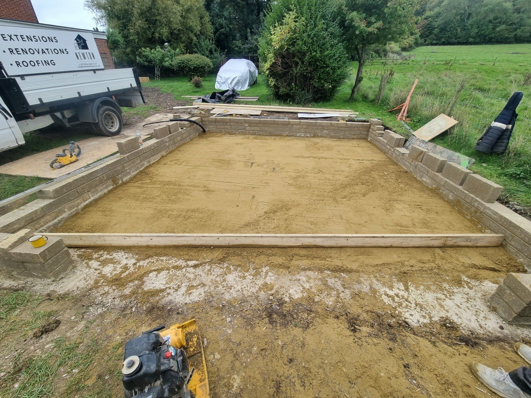 A construction site with a truck parked in the background.