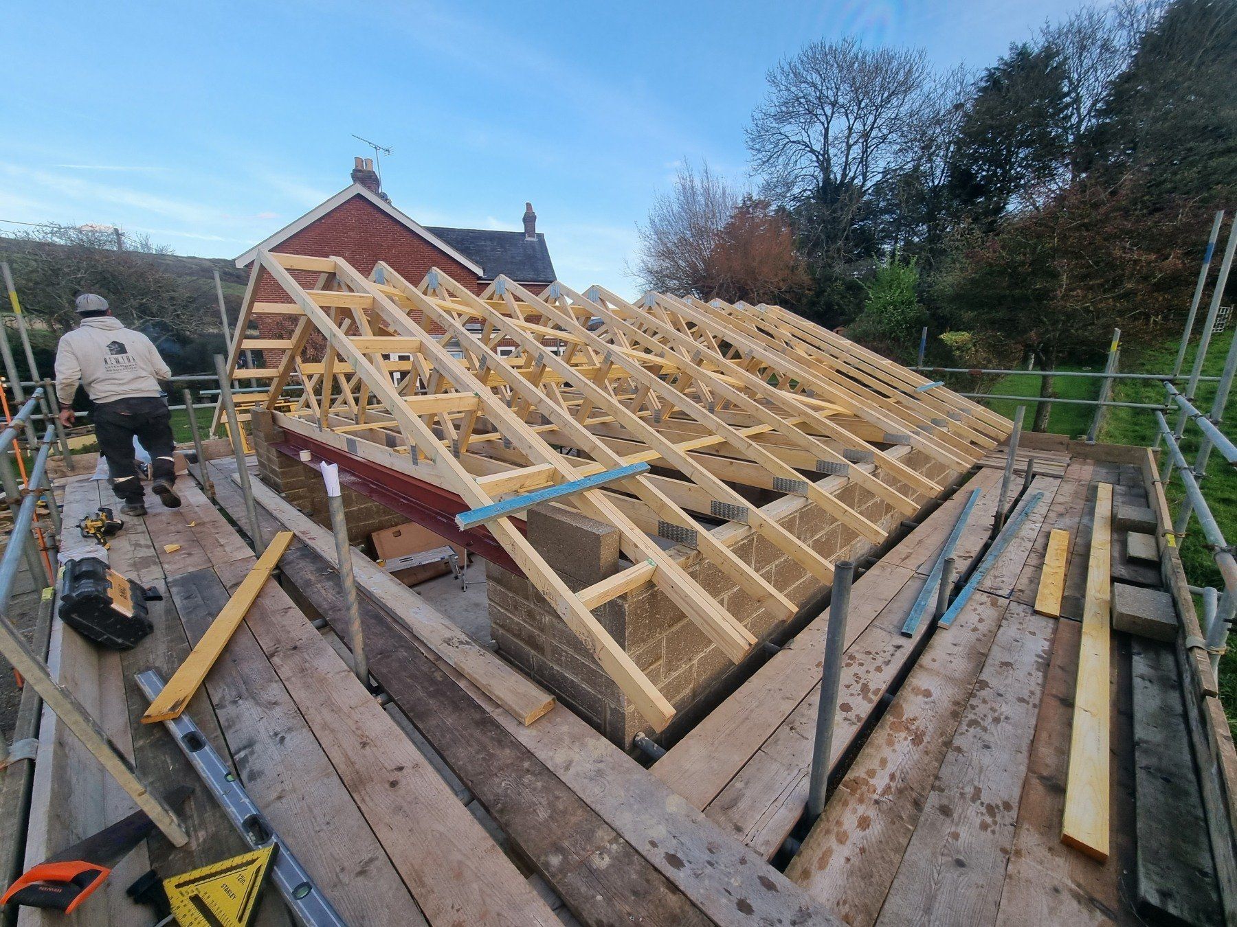 A man is working on the roof of a house.