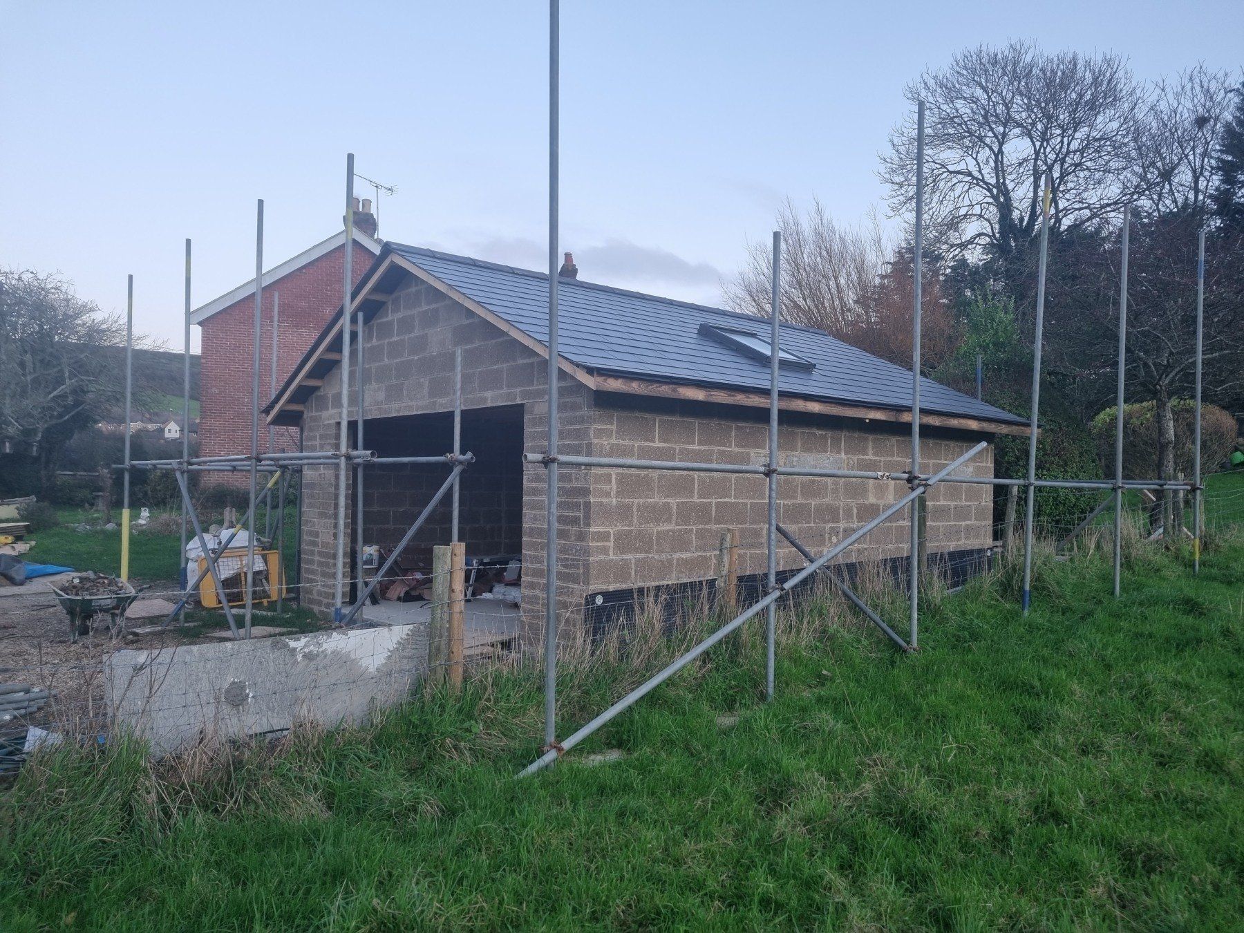 A brick building is being built with scaffolding around it.