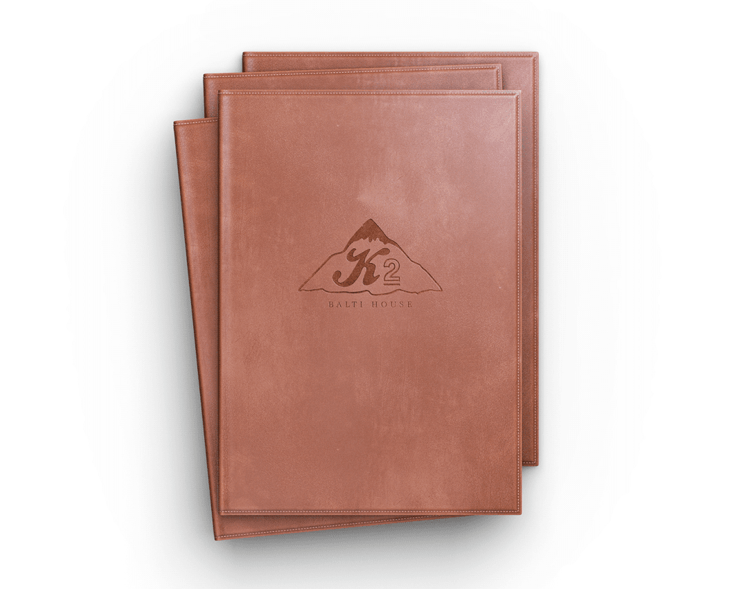A brown leather menu with the K2 Balti House Restaurant on it