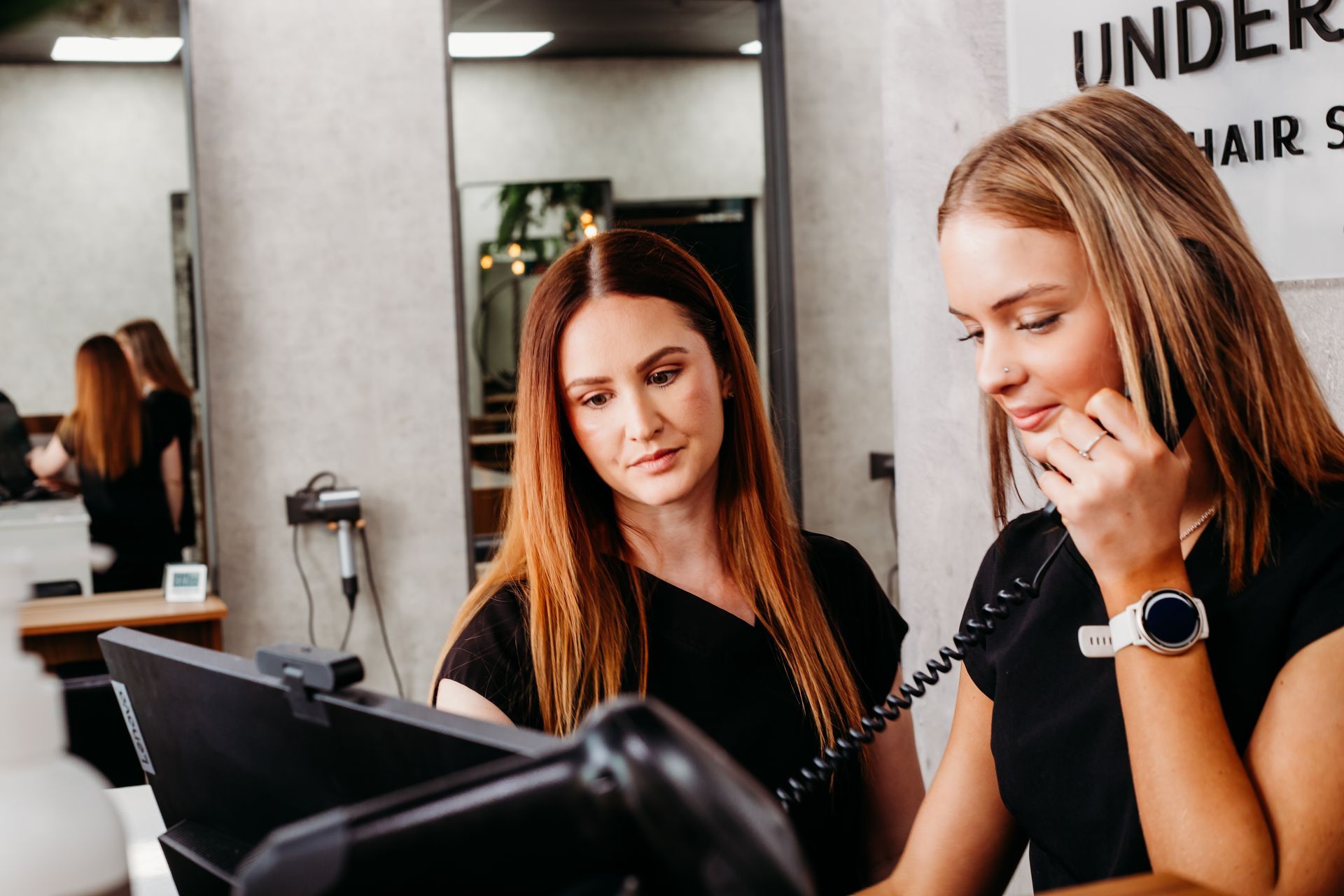 A Woman With Red Hair Is Standing In A Salon — Underwraps Hair Studio In Douglas, QLD