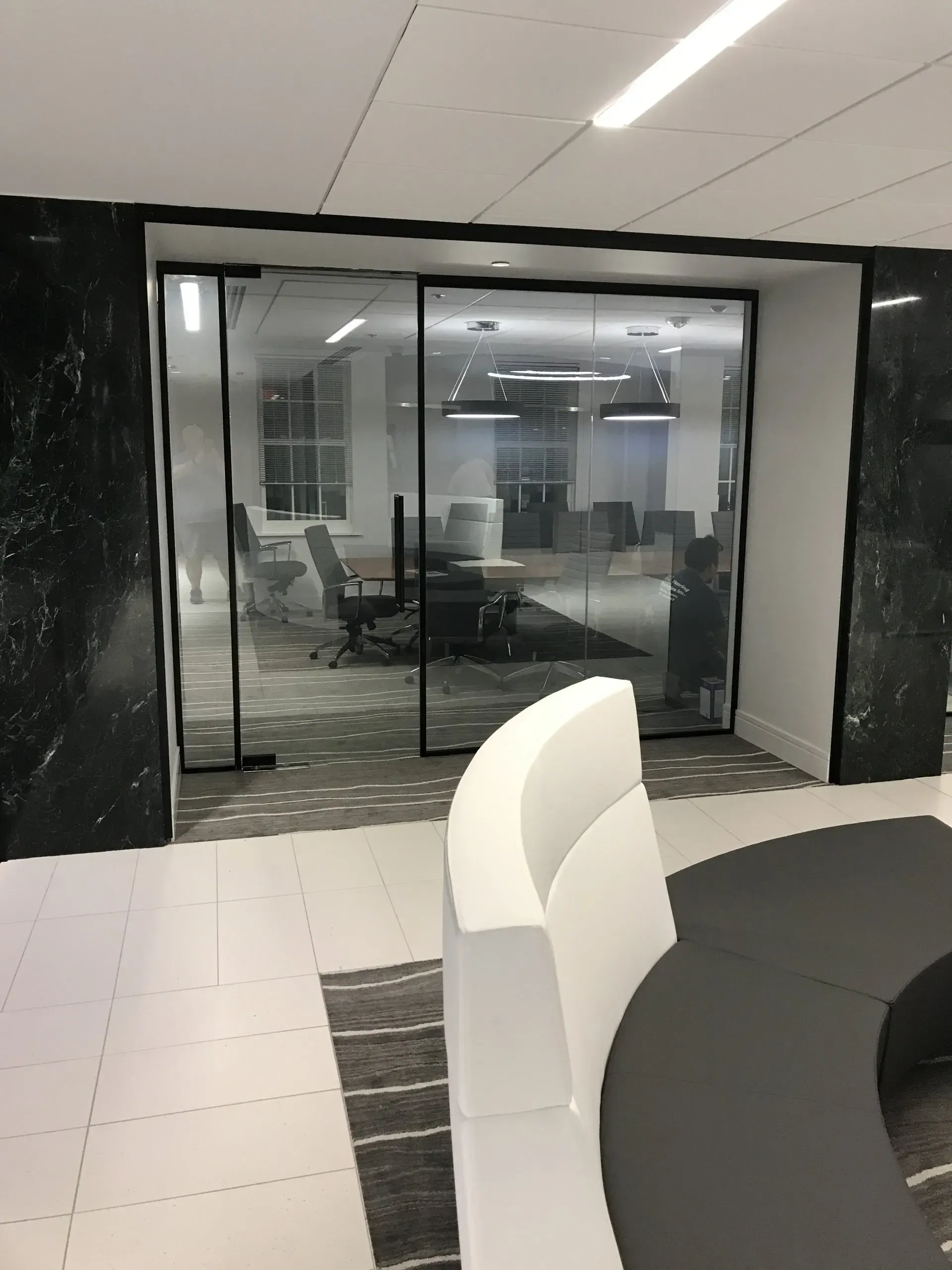 A conference room with sliding glass doors and a round table.