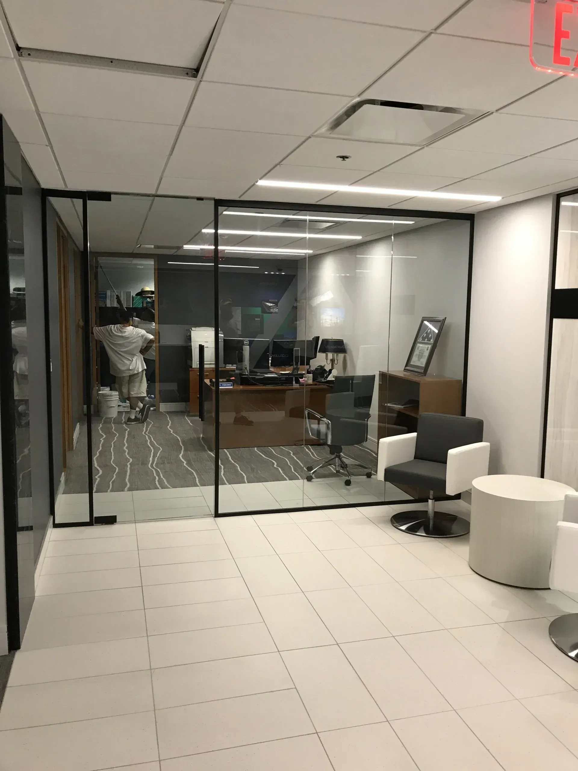 A large room with a glass wall and chairs in it.