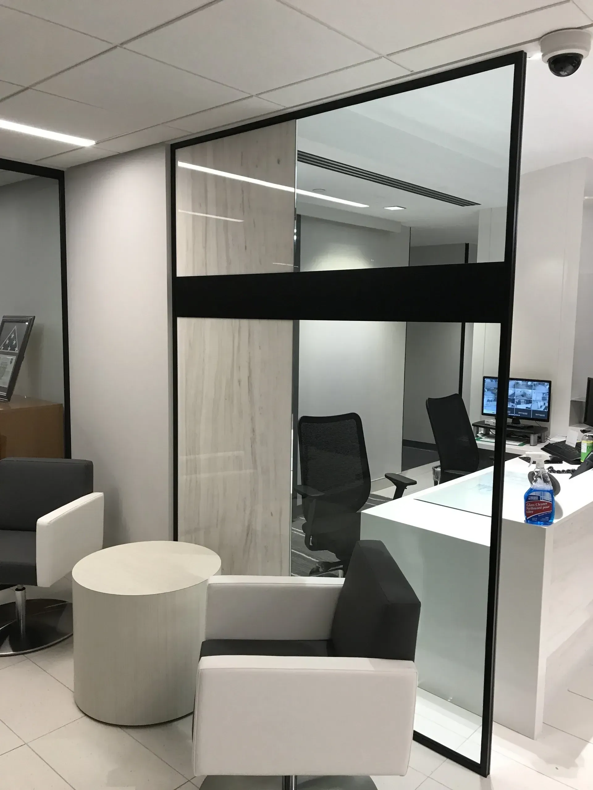 A room with a couch , chairs , and a table in it.