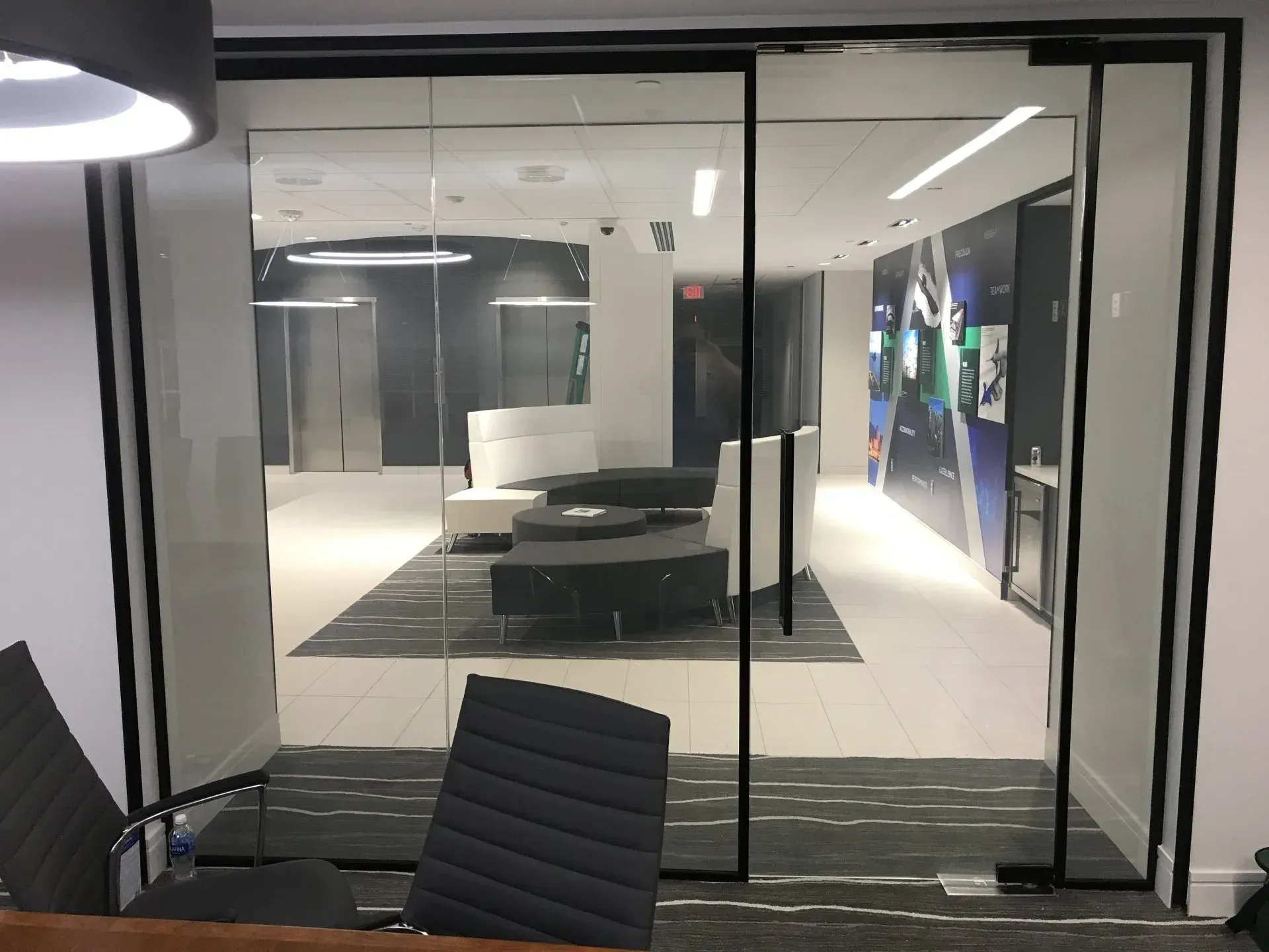 A conference room with sliding glass doors and chairs