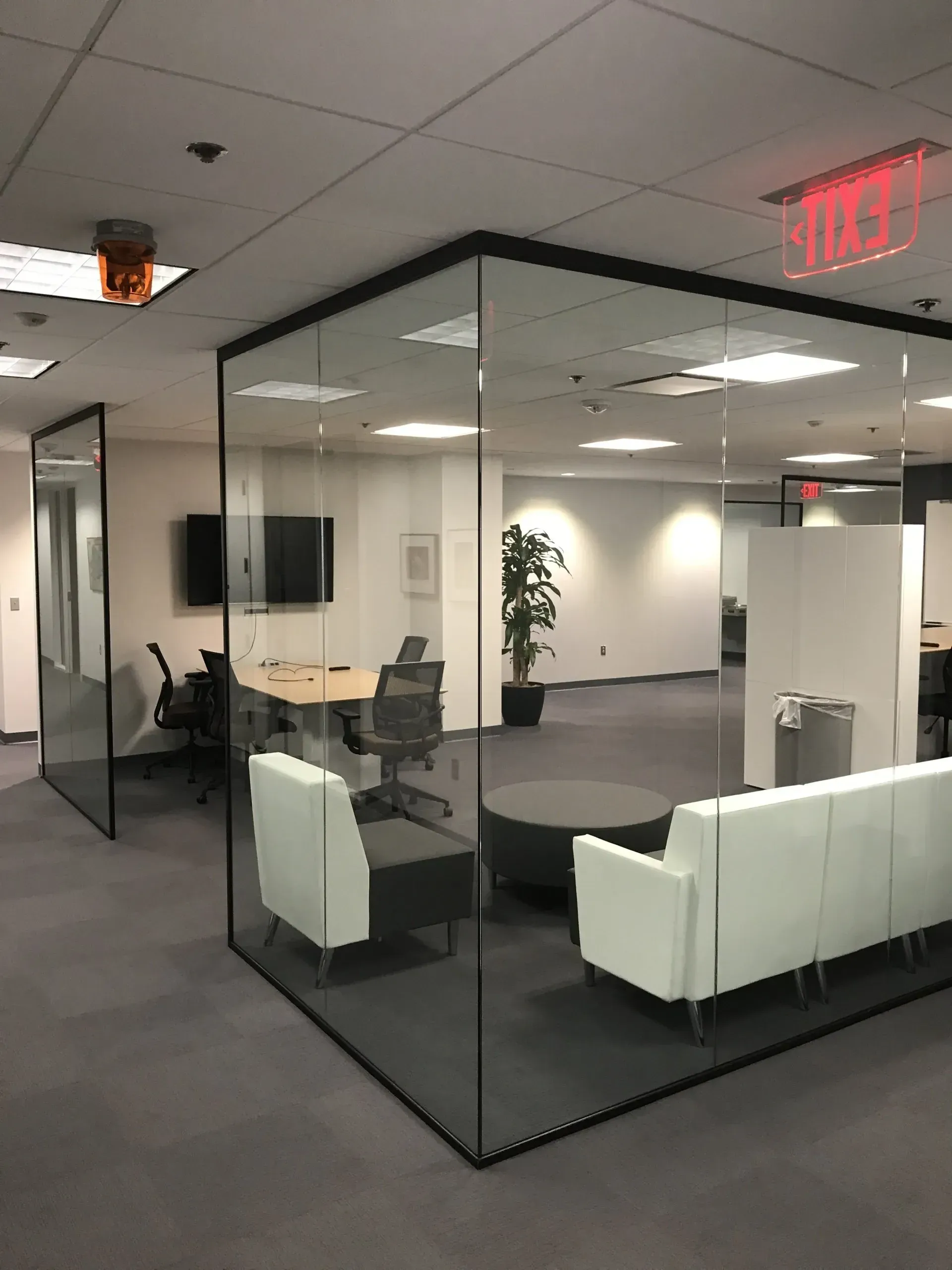 A large room with a couch and chairs in it