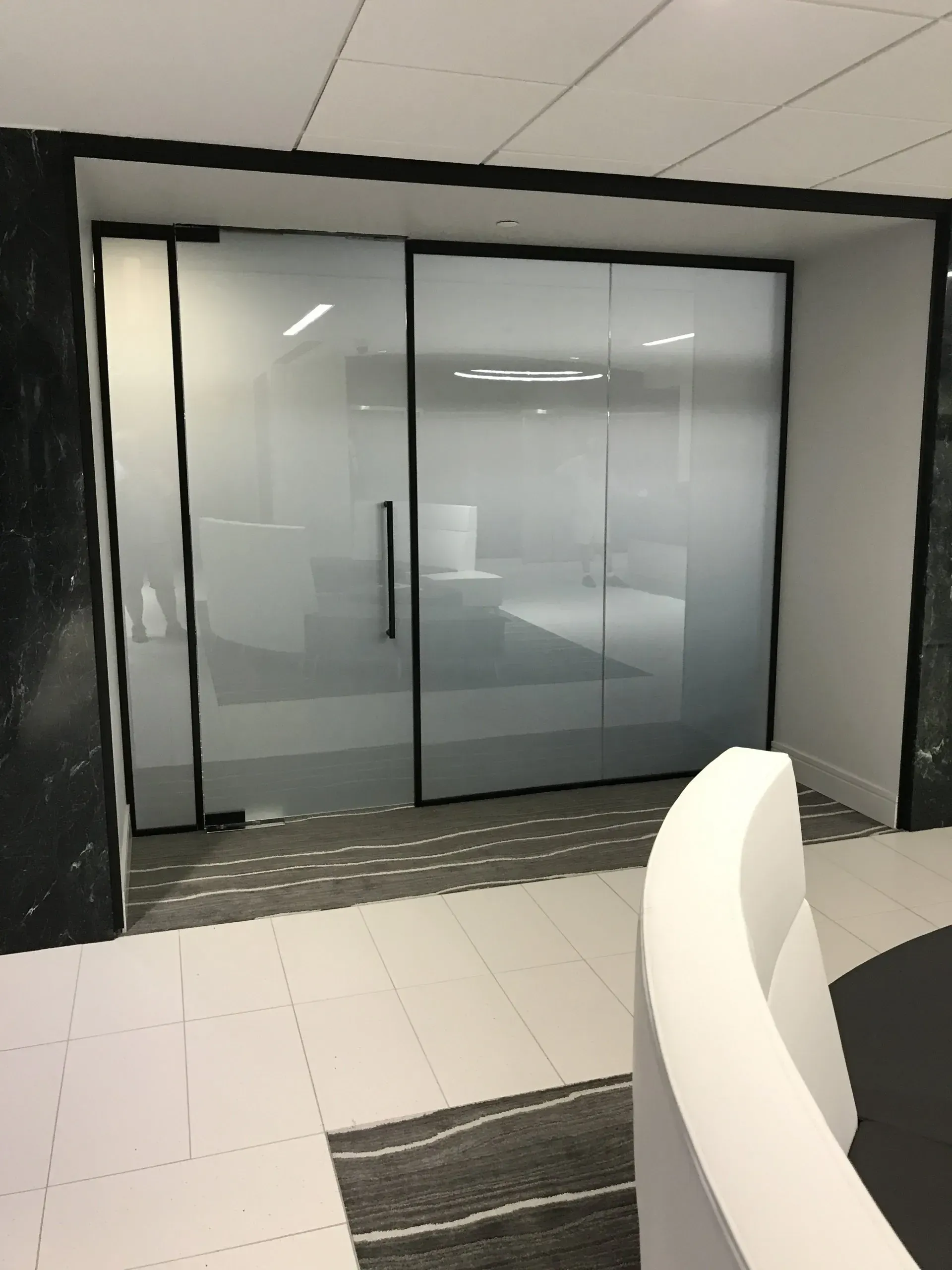 A room with a sliding glass door and a staircase