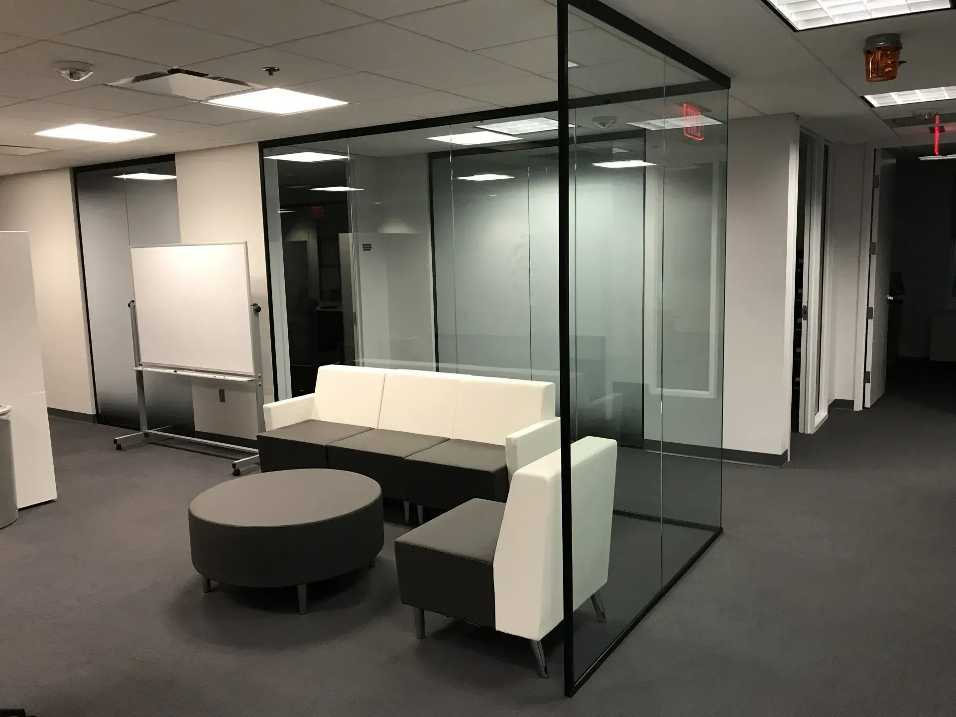 A living room with a couch , chairs , and a round table.