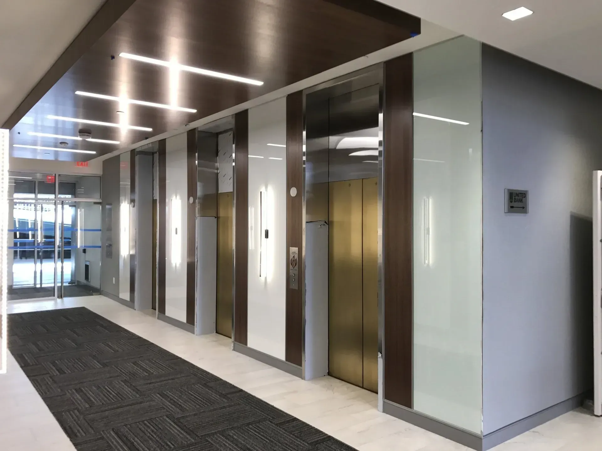 A long hallway with elevators in a building