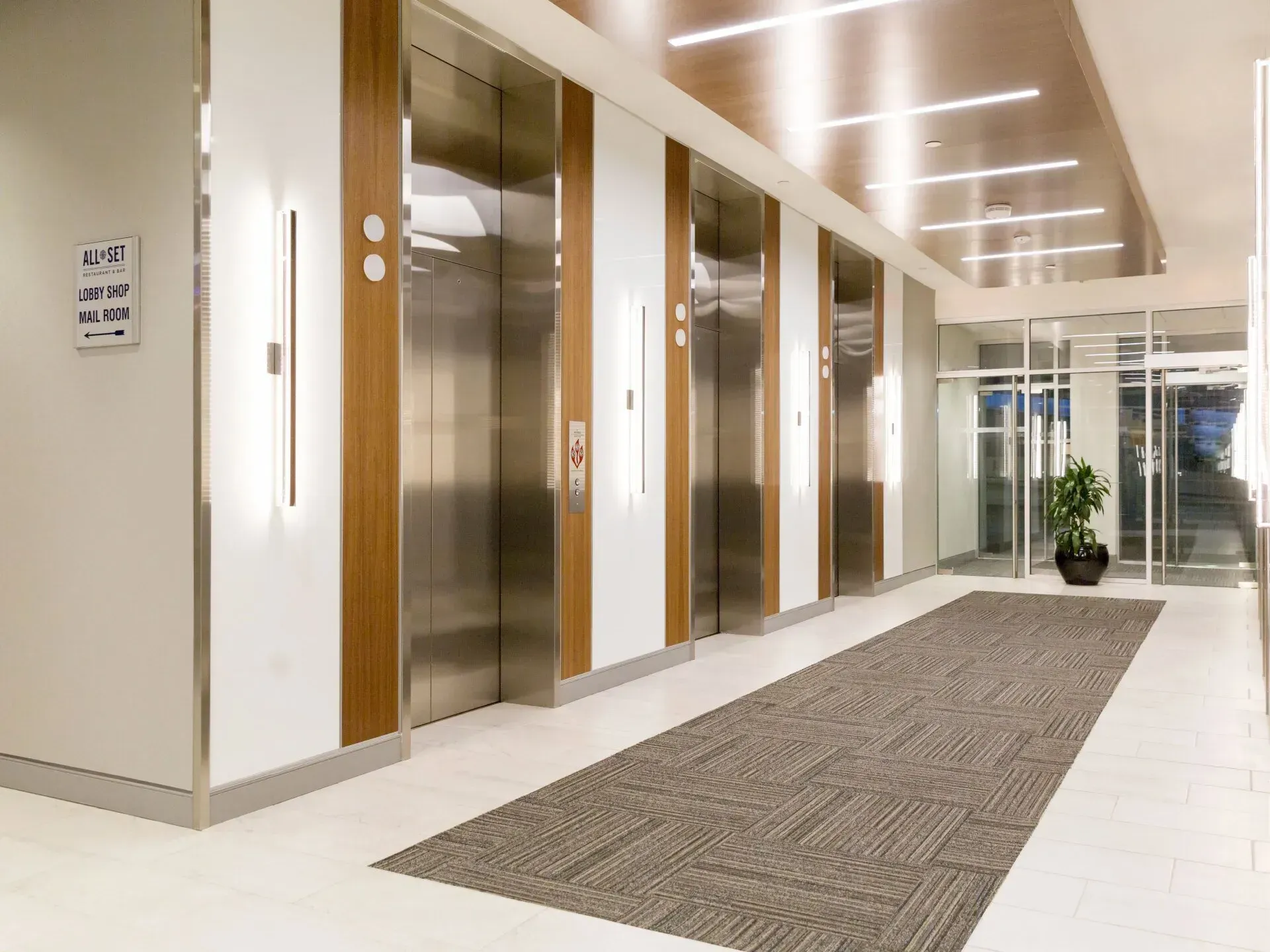 A long hallway with elevators in a building.