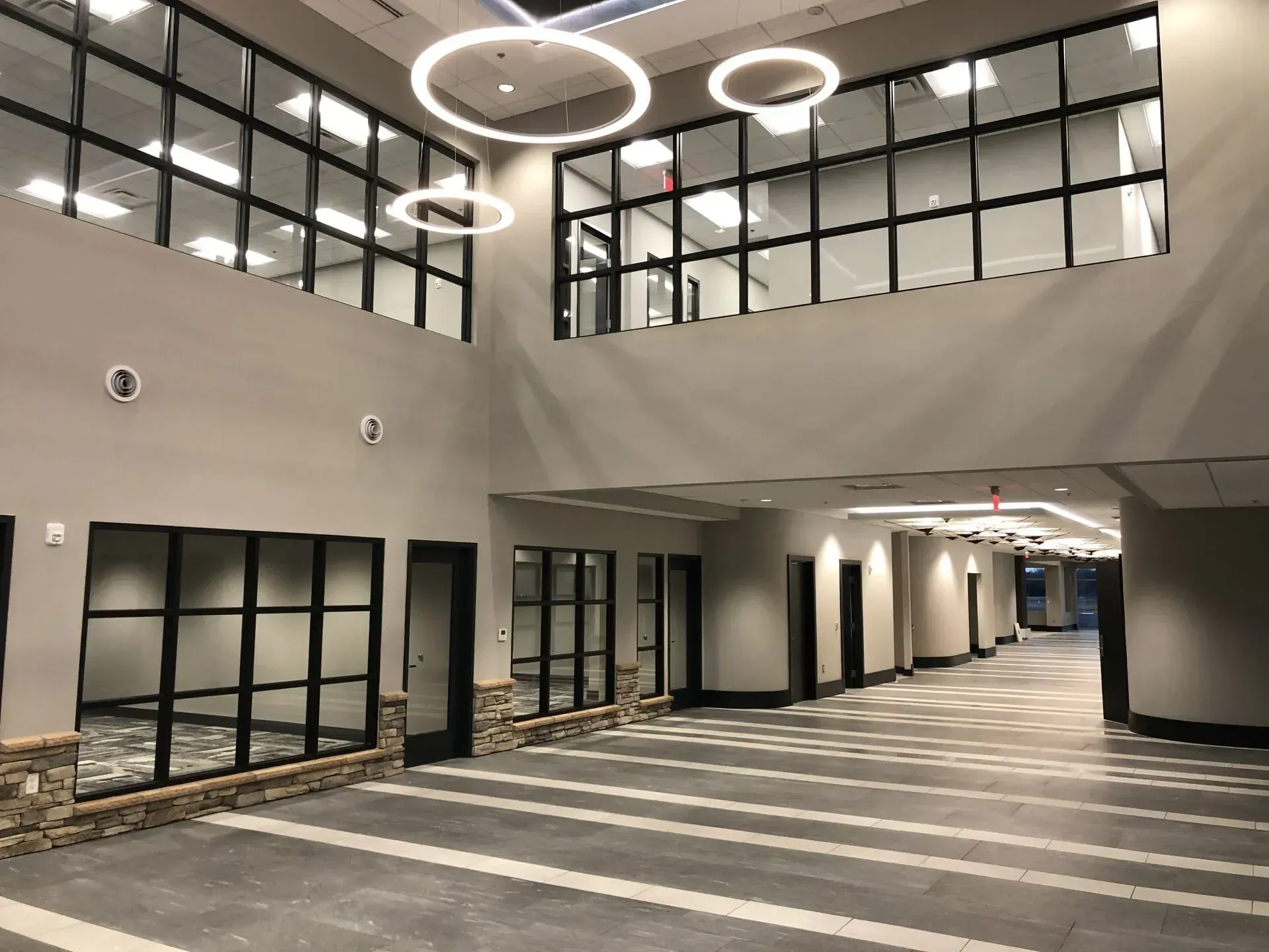A large empty building with a lot of windows and doors