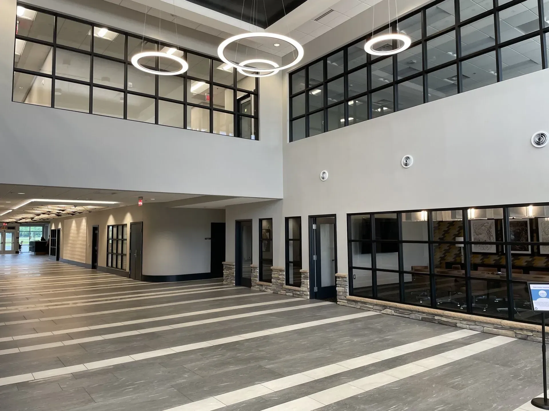 A large lobby in a building with a lot of windows.